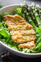 salad bowl chicken meat, asparagus, greens salad leaves vitamin eating organic diet on the table healthy food meal snack copy space food background rustic. top view keto or paleo diet veggie 