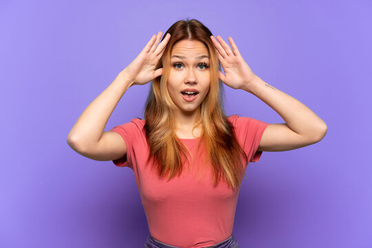 Teenager girl over isolated purple background with surprise expression
