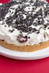 home made cheesecake with cherries and chocolate shavings 