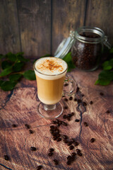  cup of cappuccino coffee with foam on rustic background