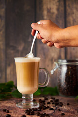  cup of cappuccino coffee with foam on rustic background