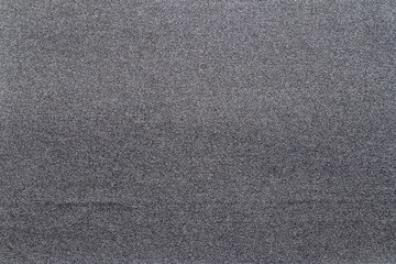 Sandpaper texture background gives a beautiful pattern of black sand grains on sandpaper, suitable as a background for inserting text. Copy Space for designers to use on sandpaper.