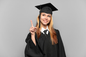 Young university graduate girl over isolated background pointing up a great idea