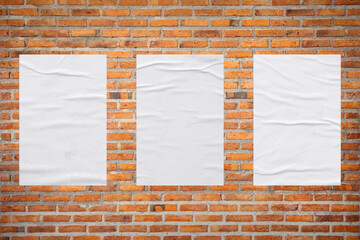 Blank white wheatpaste glued paper poster mockup on brick wall background