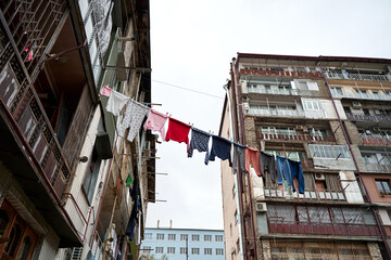 Fototapeta na wymiar Household traditions in Georgia. Linen and clothes are dried outside on balconies and ropes between buildings