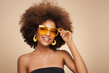 Beauty portrait of African American girl in sunglasses. Beautiful black woman. Cosmetics, makeup and fashion