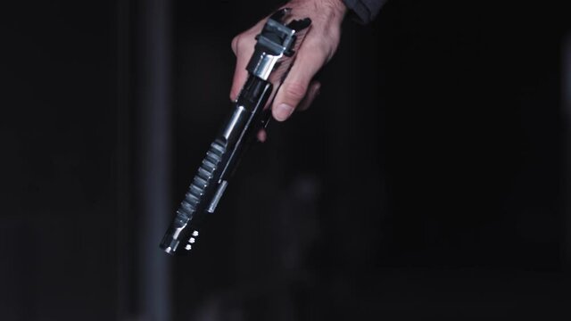 A man doing badass manipulates his gun