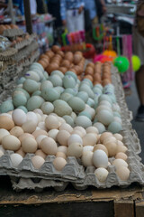 Denpasar, Bali, Indonesia (June 19, 2021): Display of various types of eggs on traditional market shelves.