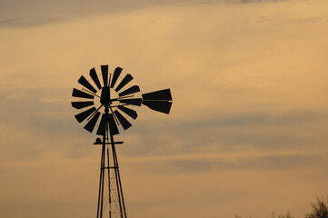 Old windmill seen from afar during sunset, near Barker, Colonia, Uruguay
