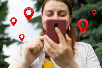 Traveler woman uses map on mobile phone app to search for route location of place with gps on...