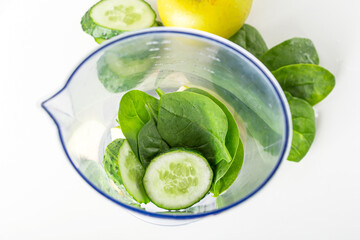 Smoothie recipe. Ingredients for green smoothie: spinach, apple, cucumber in blender. Home cooking. Vegan healthy detox eating, dietary and weght loss drink