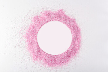 Pink dried strawberries powder like as frame circle on white background with copy space for text....