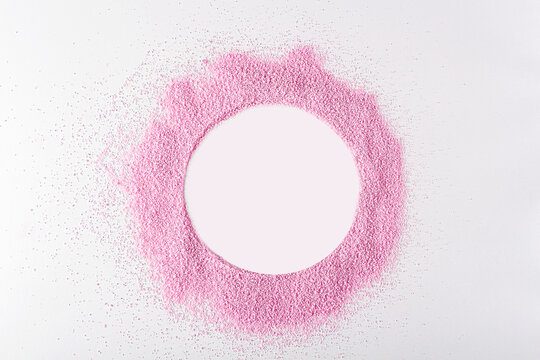 Pink dried strawberries powder like as frame circle on white background with copy space for text. Textured fruit starch,  jelly, gelatin for cooking ingredients.