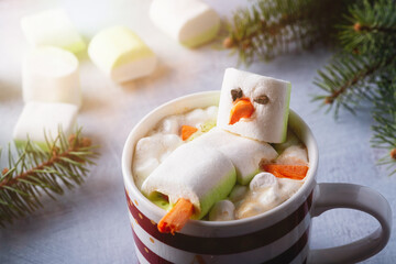 Christmas card with cup of hot chocolate with melted marshmallow snowman