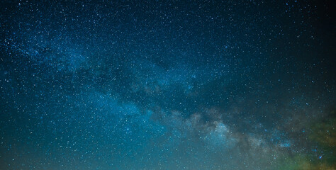 On the starry night sky, the Milky Way. The bright blue colors of the sky and the quiet twinkling...