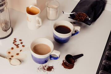 Two cups of coffee in blue and white mugs in modern kitchen