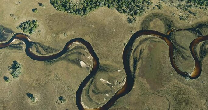 Spectacular high aerial panning view of the beautiful scenic curving patterned waterways and lagoons of the Okavango Delta