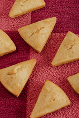 Sliced cornbread on purple and pink tiled background