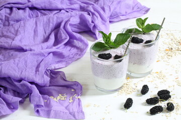 Curd dessert with chia seeds and mulberry on white plate