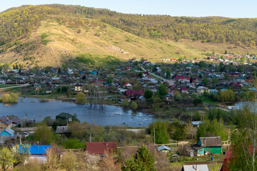 Small town on the background of the river and mountains.