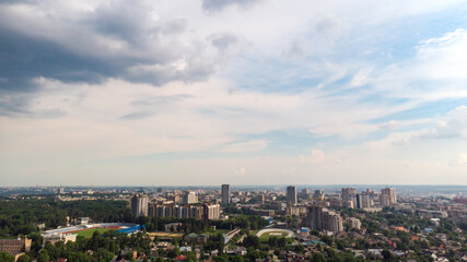 Aerial panoramic cityscape view on green summer Kharkiv city center, stadiums, parks. Multistory modern high residential buildings on bright sunny day