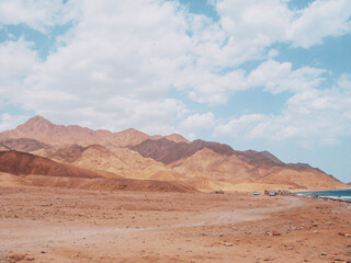 Fototapeta na wymiar Egypt Vacation Photos - Empty desert with mountains and sky 