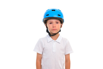 A little boy with tears in his eyes, very upset and distressed, stands on a white isolated background in a blue bicycle helmet.