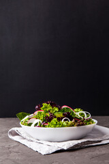 Healthy salad, leaves mix salad in a bowl over dark background. Copy space. - 441646882