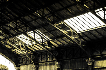 Huge roof of a steel shed and metal sheets. Old train station roof.