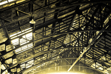Huge roof of a steel shed and metal sheets. Old train station roof.