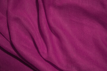 Fototapeta na wymiar Purple cotton fabric, soft and wavy.