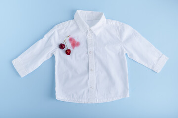 Juice stain with stain remover spray for clothes. Isolated on a blue background. top view. isolated on blue background