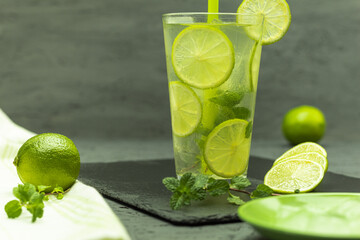 A glass of lemonade and ice with lime