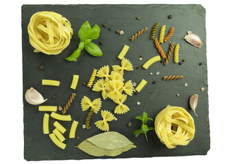 A set of pasta and noodles with spices on a stone cutting board