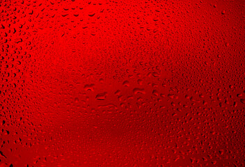 drops of water on a red background. texture of water droplets.