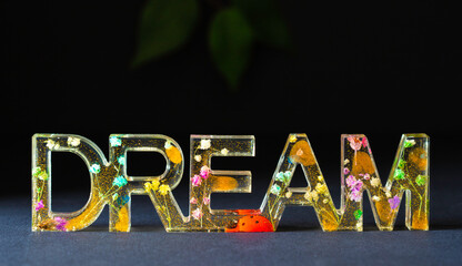 Dream word decoration and inspiration epoxy resin black background