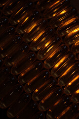 gold capsules under contrast lighting
