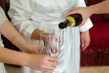 person pouring champagne into glass