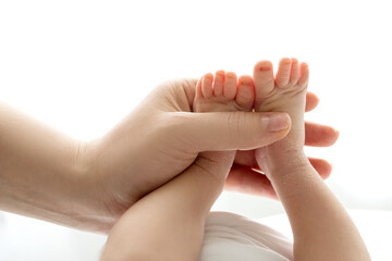 hands of parents. the legs of the newborn in the hands of mom and dad. baby's legs in his hands. 