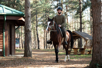 Young Man Sitting on a Horse Outdoors