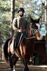 Young Man Wearing Helmet and Riding Horse