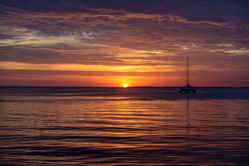 Seascape. Boat on sea. Sailboats at sunset. Ocean yacht sailing along water.