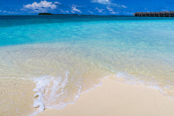 Waves lapping on white sand beach, South Ari Atoll, Maldives