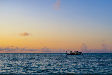 Wooden boat at Sunset in the Maldives