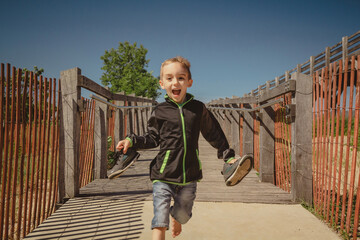 Boy running down a ramp at the Indiana Dunes State Park Bird Observatory