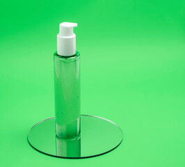 cosmetic container with green gel or foam, cosmetics with aloe vera