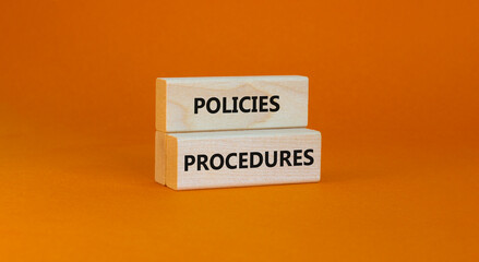 Policies and procedures symbol. Wooden blocks with concept words Policies procedures on orange background. Business and policies and procedures concept. Copy space.