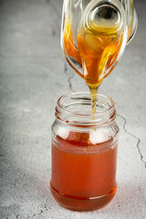 Honey in glass jar on the table.
