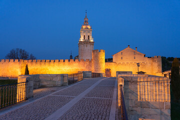 View of the medieval village of Burgo de Osma, the walls and the cathedral tower illuminated at night, Soria, Castilla y León, Spain.