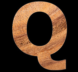 Alphabet letter Q on rustic wooden background